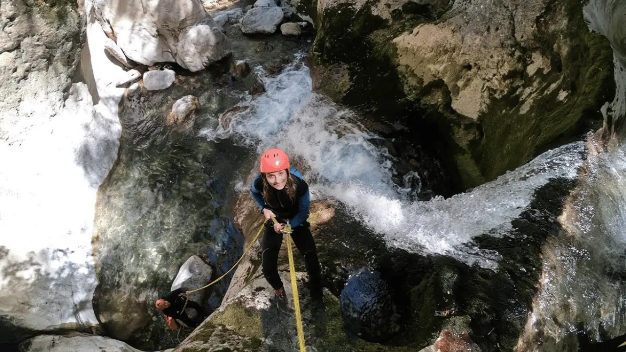 Canyoner abseiling beside a waterfall in the Hrčavka canyon, Sutjeska National Park